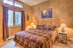 Master bedroom features a king bed, tv, and ensuite bathroom
